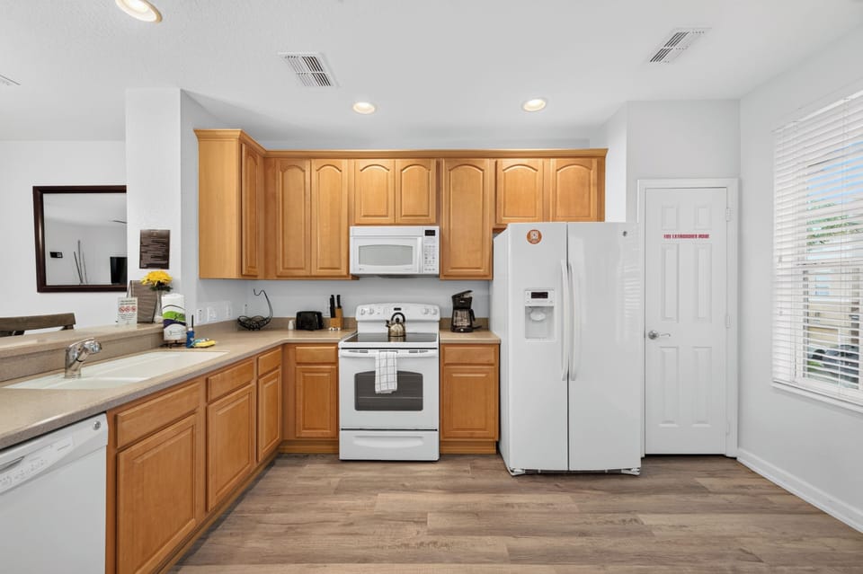 Your fully-equipped kitchen features warm wood cabinetry, modern appliances, and plenty of counter space—perfect for preparing your favorite meals during your stay.
