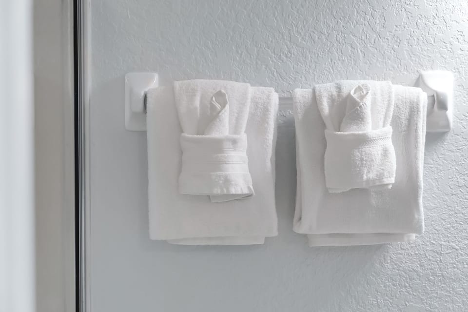 Fresh, fluffy towels await your arrival, perfectly arranged for your comfort and convenience.