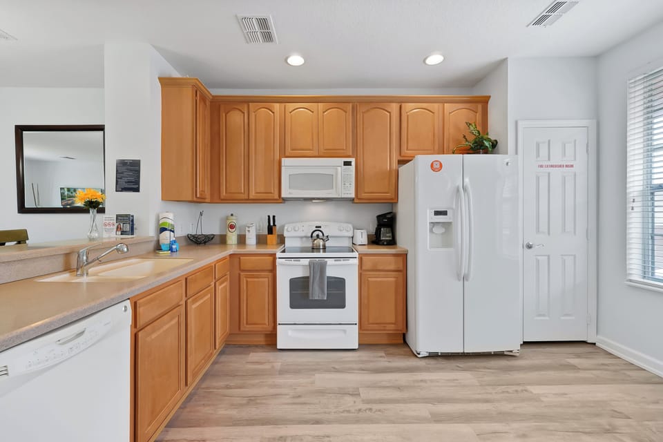 Your fully equipped kitchen awaits with warm wood cabinets, modern appliances, and everything you need to prepare memorable meals during your stay.
