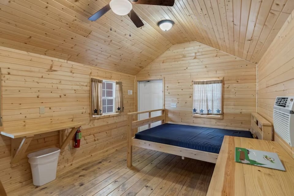 Unwind on a simple cabin bed in warm pine.
