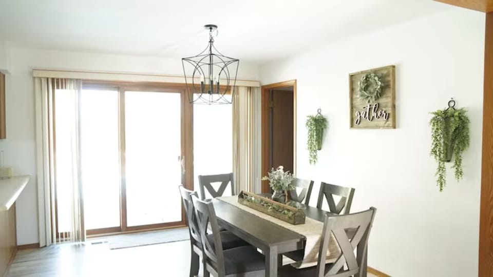 Gather for shared meals beside bright patio doors and greenery.