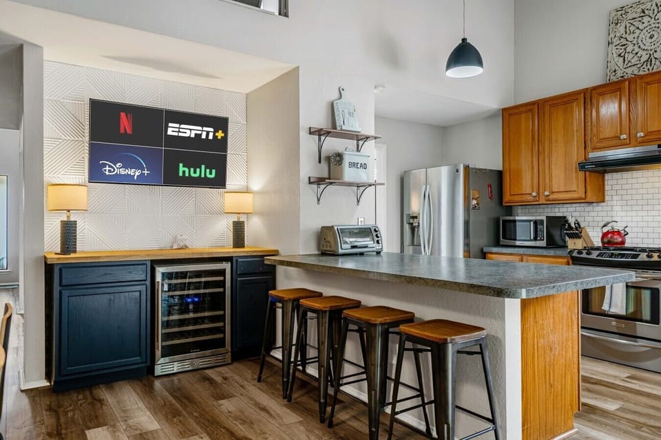 Settle into the breakfast bar for a casual meal or social hour with the Smart TV nearby.