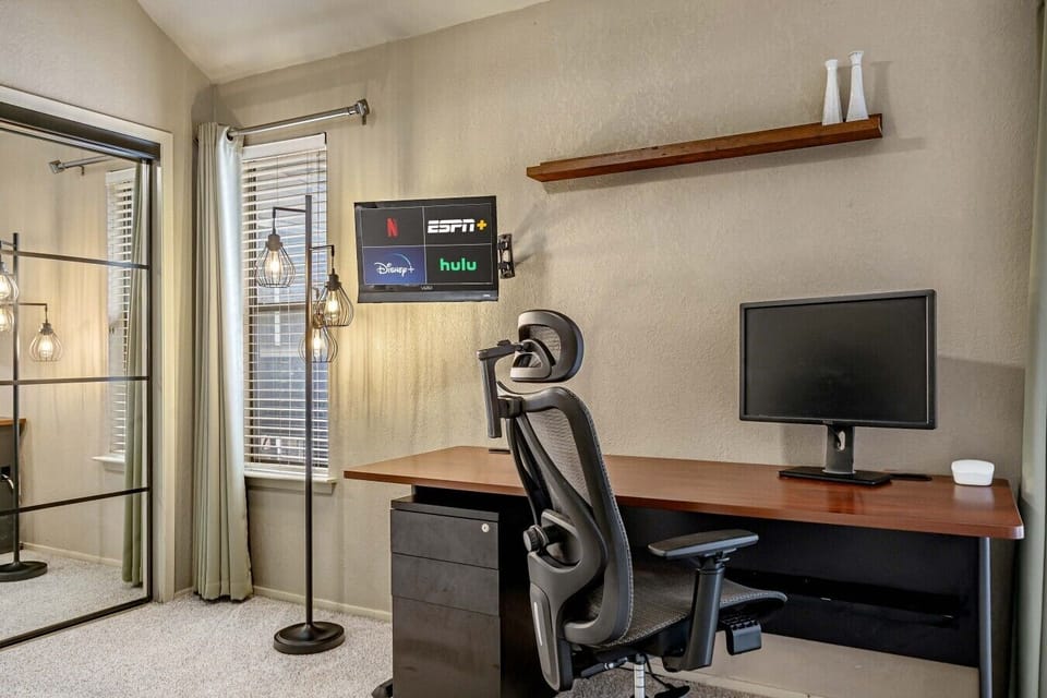 A private workspace with a desk, monitor, and comfortable chair makes it easy to stay productive during your trip.