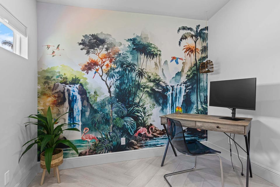 Remote work desk space with beautiful tropical wallpaper in the master bedroom