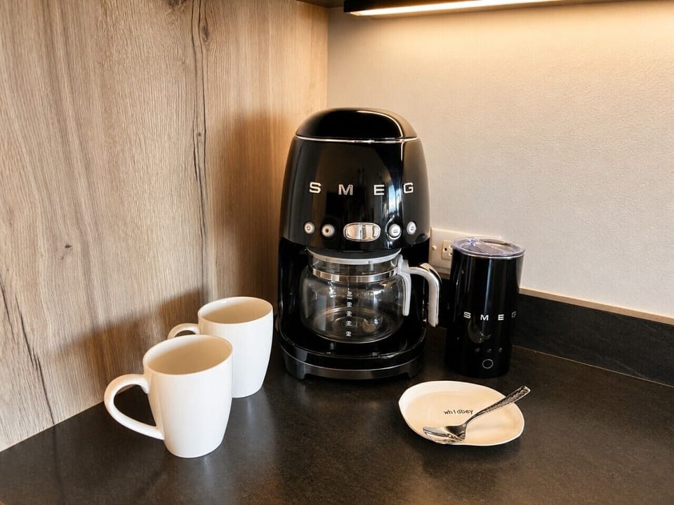 Dedicated coffee station with a stylish Smeg coffee maker, making every morning a little more enjoyable.