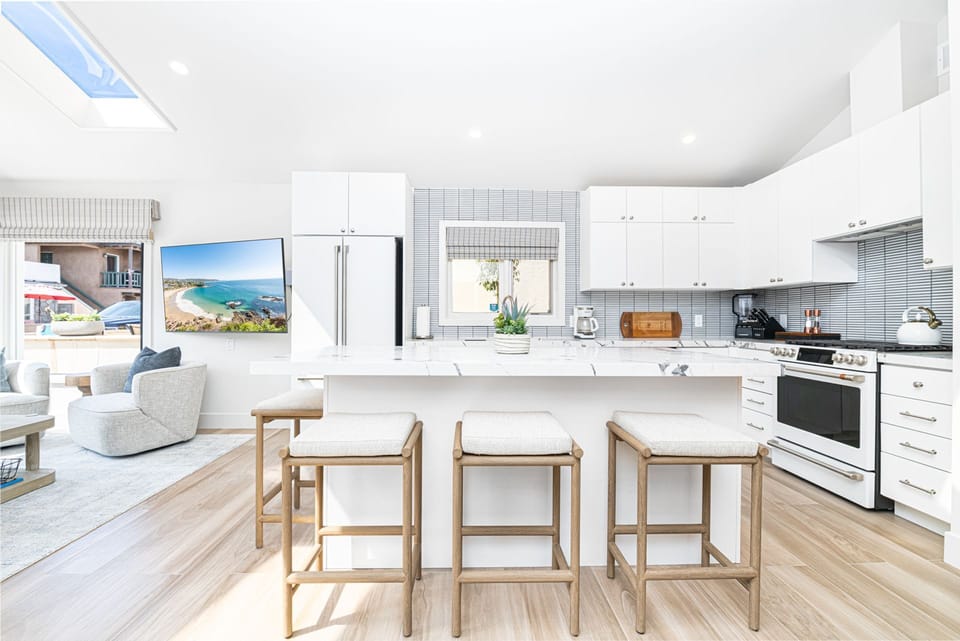 Fully renovated kitchen with sleek finishes, custom cabinetry, and modern appliances—perfect for effortless coastal living.
                