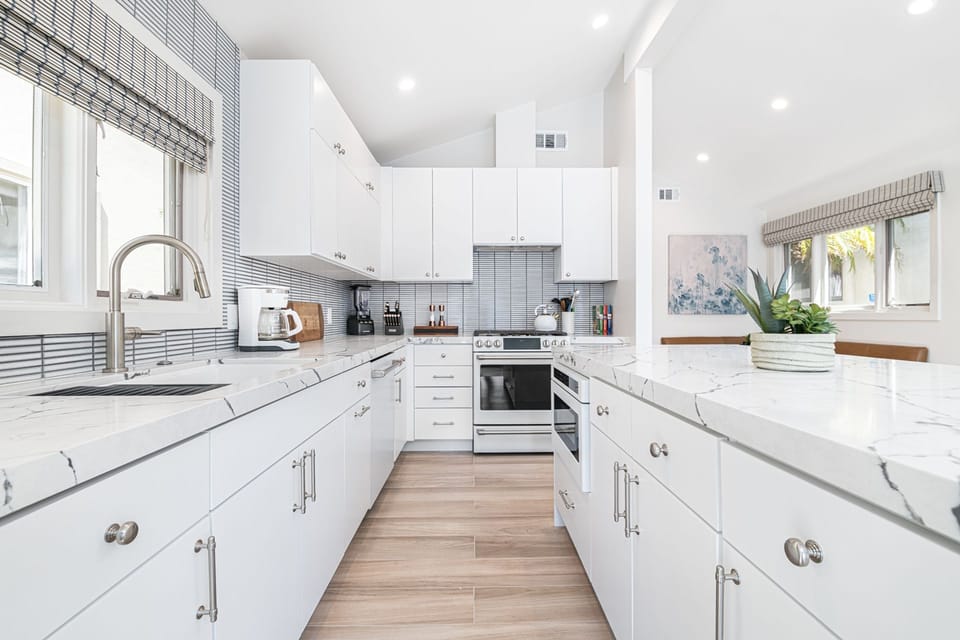 Sleek kitchen featuring brand-new appliances, modern finishes, and ample space for meal prep.
                