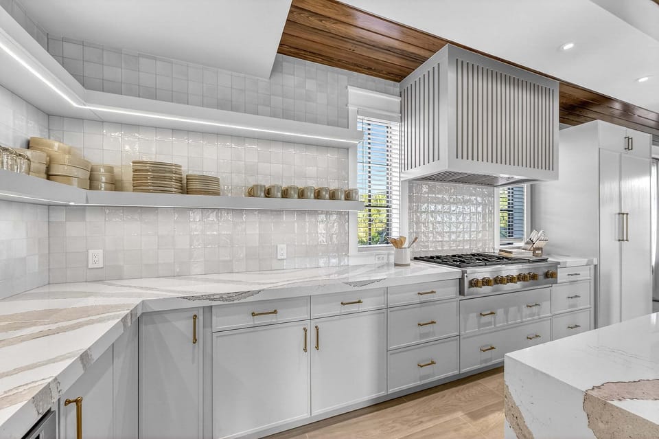 Open shelving and under cabinet lighting add both style and function.