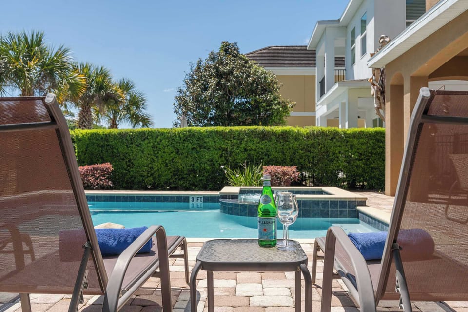 Private poolside patio w/ loungers & greenery for laid-back outdoor relaxation