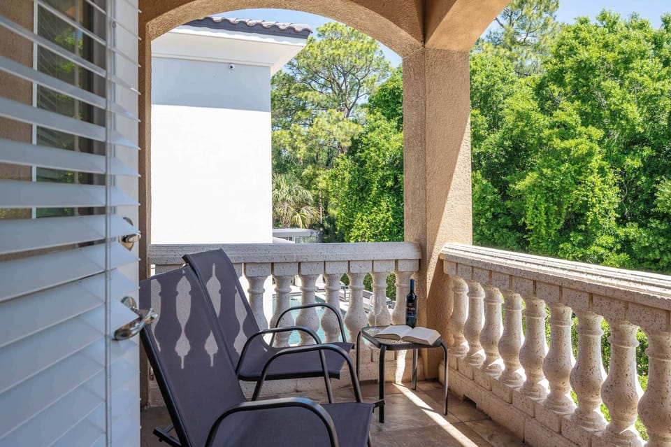 Covered balcony w/ seating, a peaceful spot to enjoy fresh air & quiet moments