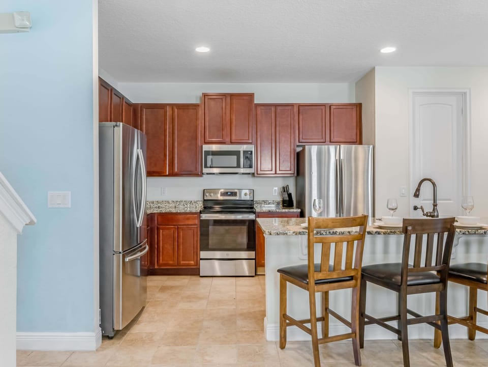 Open kitchen w/ bar seating, stainless appliances & everything needed for easy meals