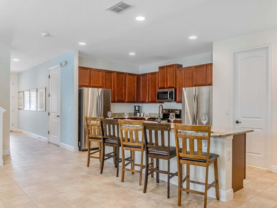 Bright kitchen w/ stainless appliances, bar seating & plenty of room to gather