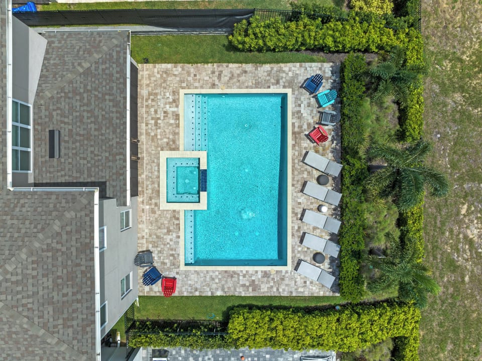 Resort-style pool area w/ loungers, hot tub & sunny outdoor space to unwind