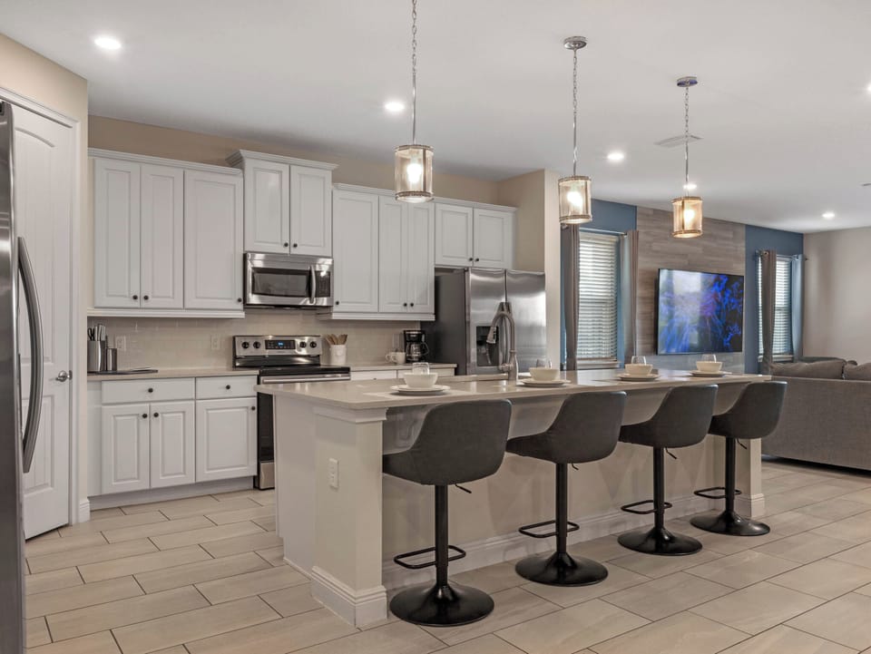 Sleek kitchen w/ stainless appliances, bar seating & plenty of space to cook together