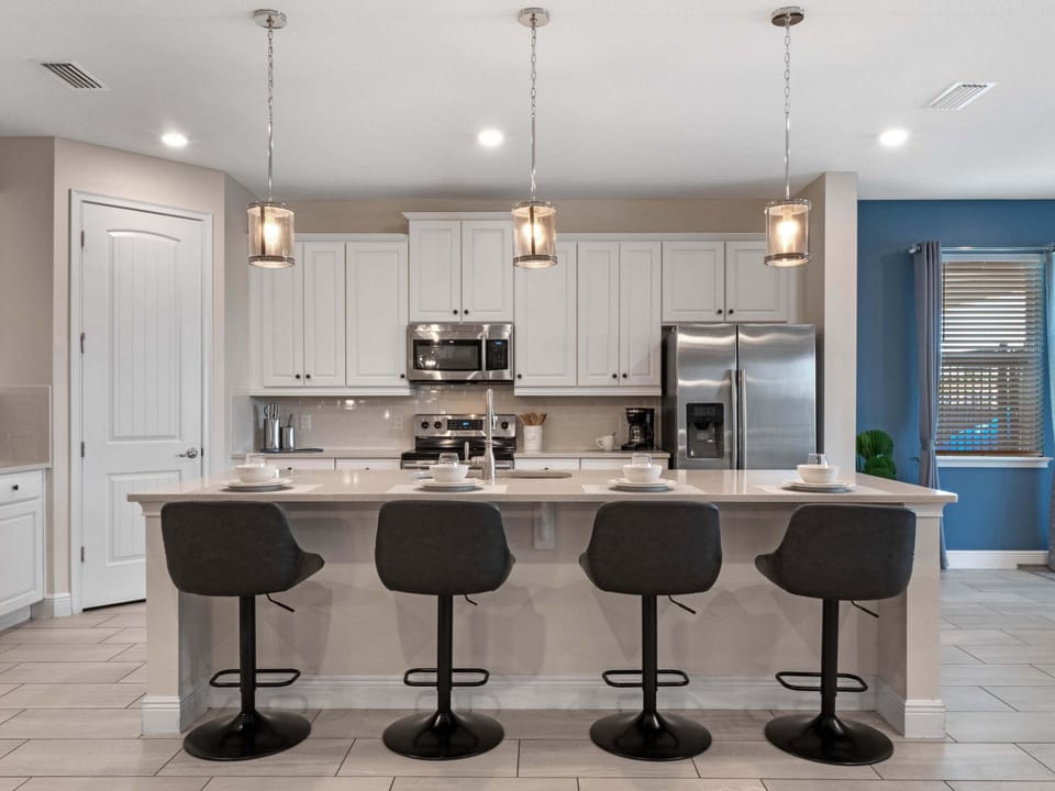Bright kitchen w/ oversized island seating, stainless appliances & modern finishes throughout