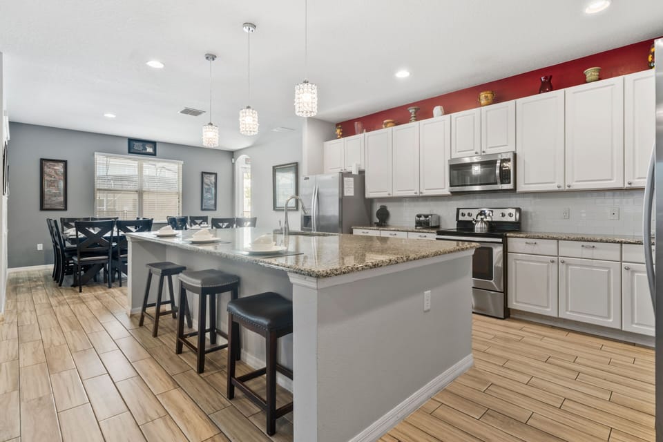Modern kitchen w/ oversized island seating, stainless appliances & room to cook together