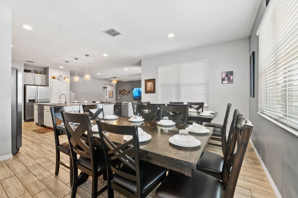 Spacious dining area w/ seating for the group, flowing easily into the open kitchen
