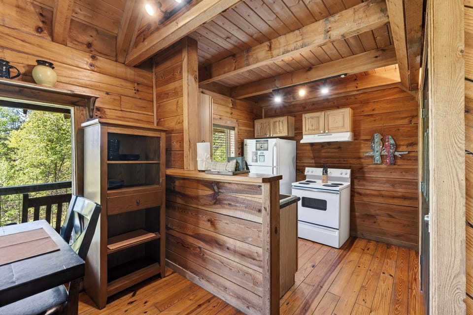 A cozy, fully equipped kitchen with rustic charm—perfect for preparing meals and gathering after a day in the mountains.
