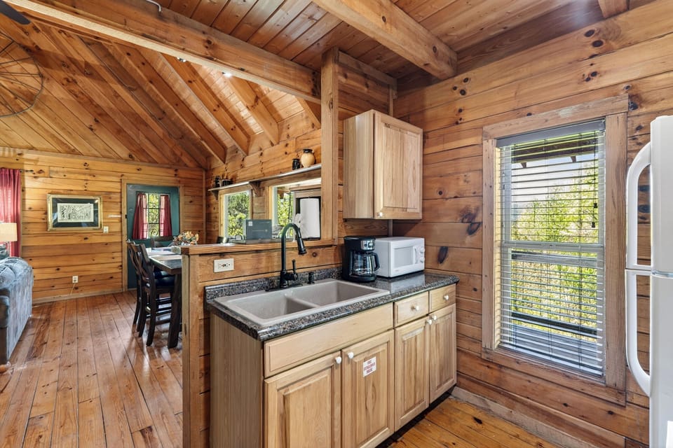 A cozy, fully equipped kitchen with rustic charm—perfect for preparing meals and gathering after a day in the mountains.