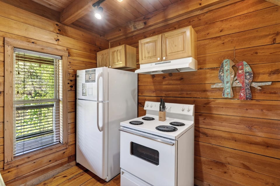 A cozy, fully equipped kitchen with rustic charm—perfect for preparing meals and gathering after a day in the mountains.