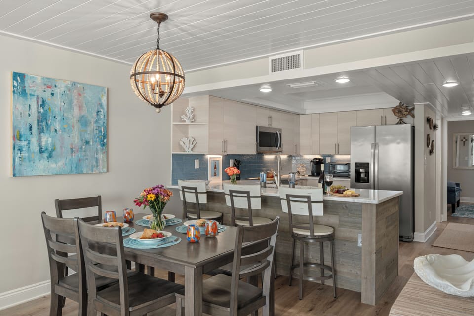 Modern dining set adjacent to the breakfast bar, perfect for family meals.