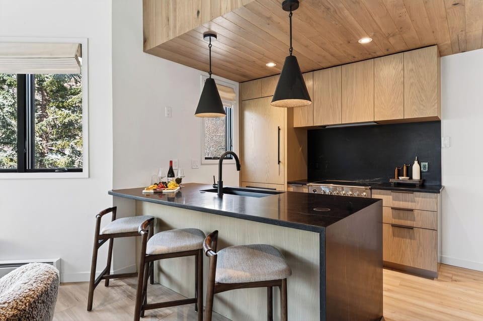 Gourmet kitchen featuring dark stone countertops and warm wood accents.