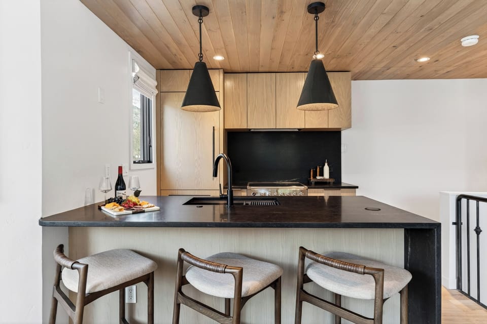 Sleek, modern kitchen with high-end appliances and a large island breakfast bar.