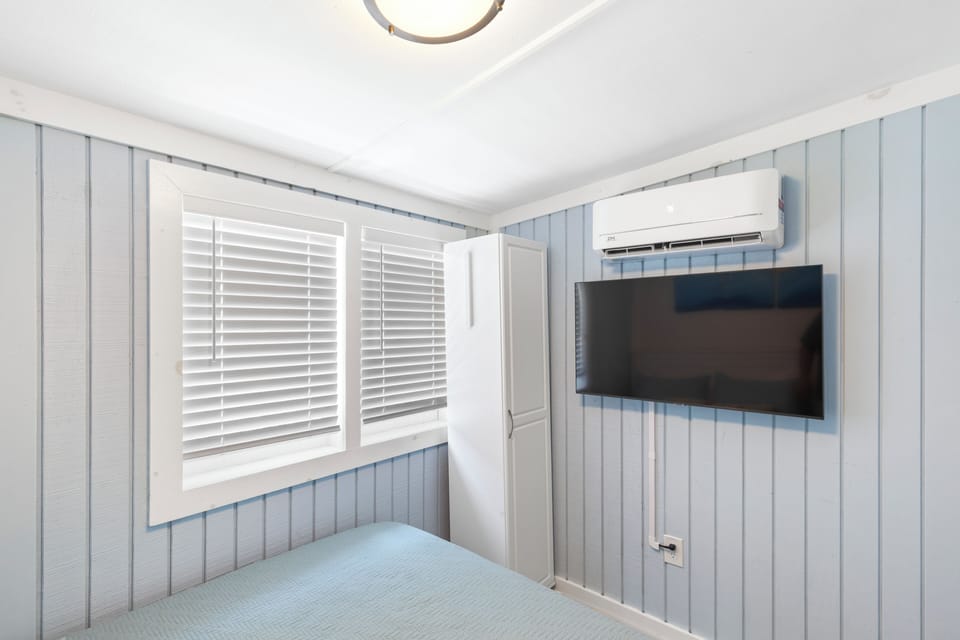 Close-up of the bedroom window and split-unit AC.