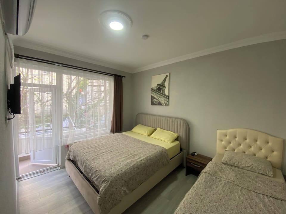 Triple Room, Balcony, Garden View | Desk, laptop workspace, free WiFi