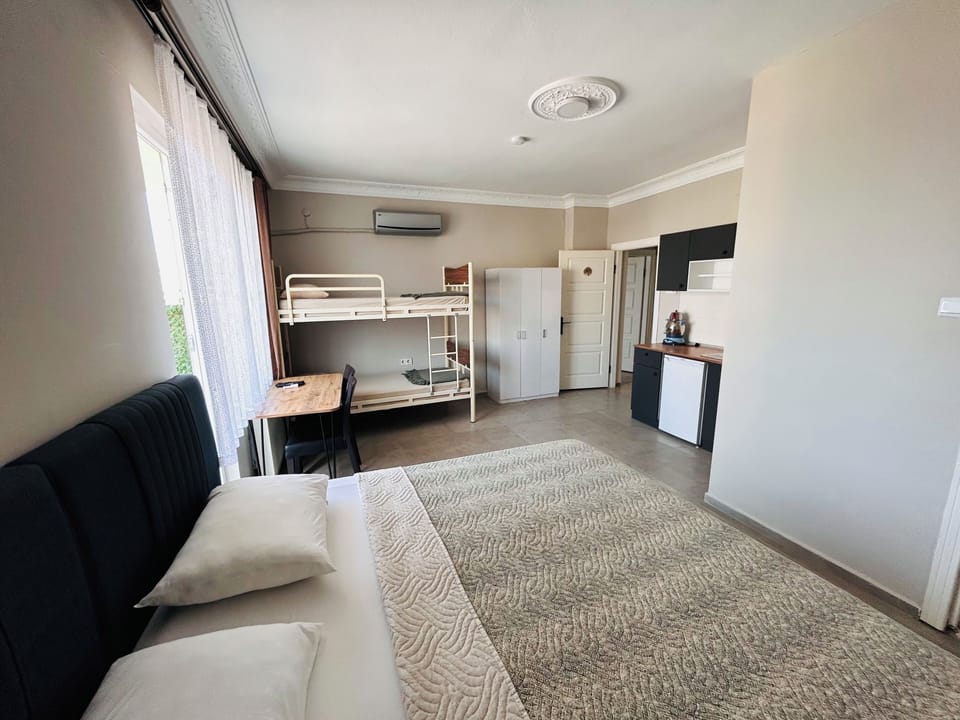 Classic Quadruple Room, Beach View | Desk, laptop workspace, free WiFi
