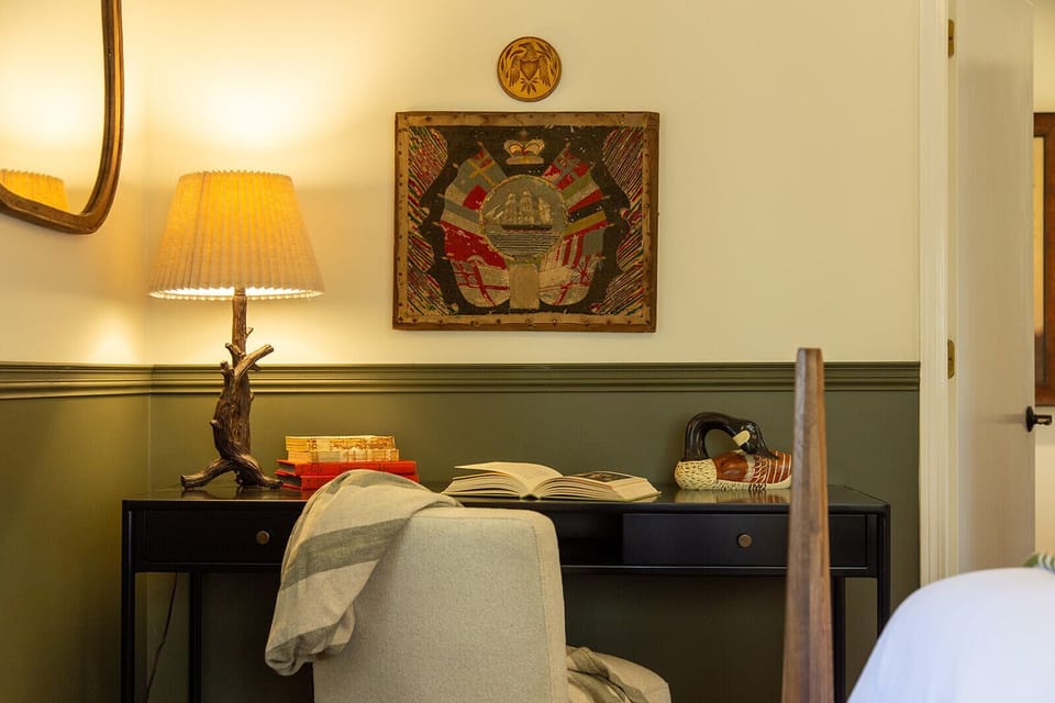 Warm lighting and curated antiques make the space feel timeless and unique.