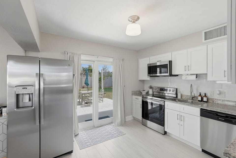 Enjoy a bright, modern kitchen equipped for everything from quick, delicious breakfasts to home-cooked dinners, with easy access to the patio for seamless indoor-outdoor living. A clean, inviting space that makes every meal feel effortless.
