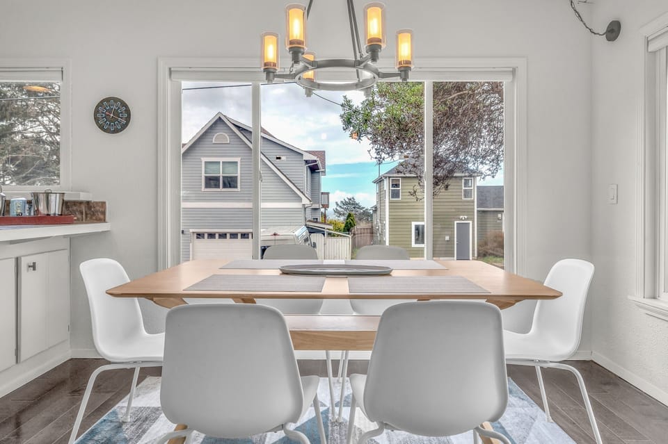 Gather around your bright dining table where warm lighting meets modern style, perfect for morning coffee or evening meals together.