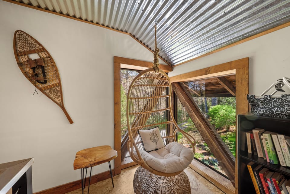 Sunlit Reading Nook with a cozy Hanging Egg Chair and peaceful wooded views