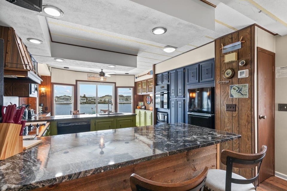 Large windows and sliding glass door where all family can come gather in the kitchen for a homecooked meal.