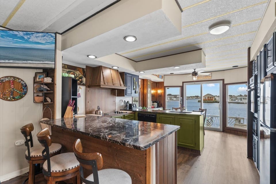 Beautiful marble countertops and modern range hood make the chief in the family eager to start cooking.