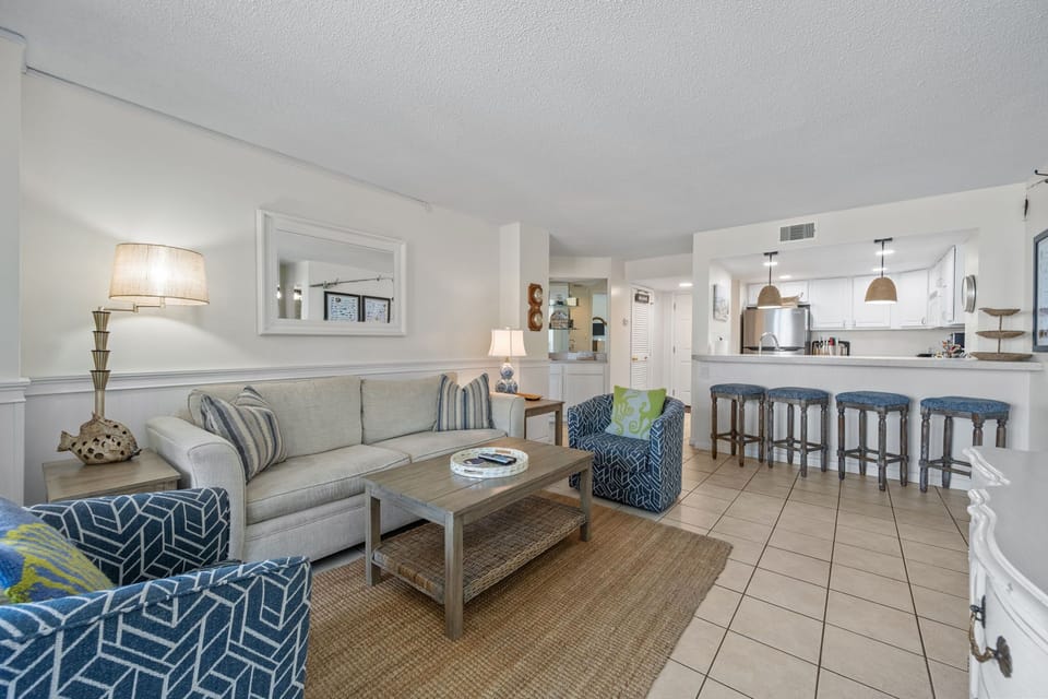 Seamless flow from living room to kitchen with bar seating for casual dining and gathering