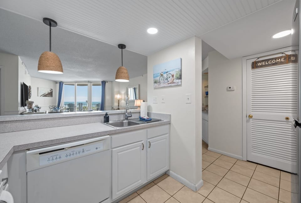Open kitchen layout with a clear view into the living space and balcony beyond