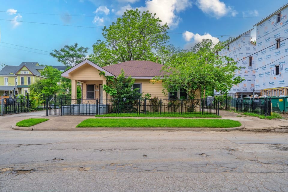 A quiet street view highlighting the fully fenced front yard.
