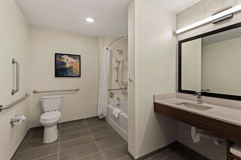 Refresh effortlessly in a bright bath with accessible comfort features.