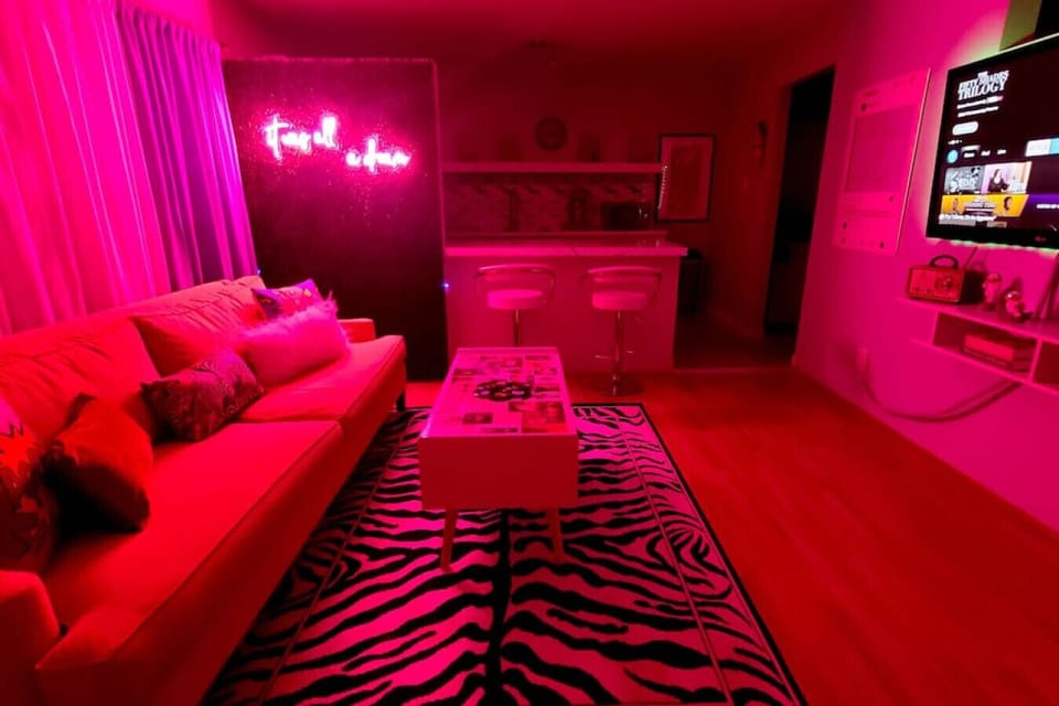 Kick back and surround yourself with art and neon lights in our retro styled living room. Bring your social media to life with the many photo ops in this room.
