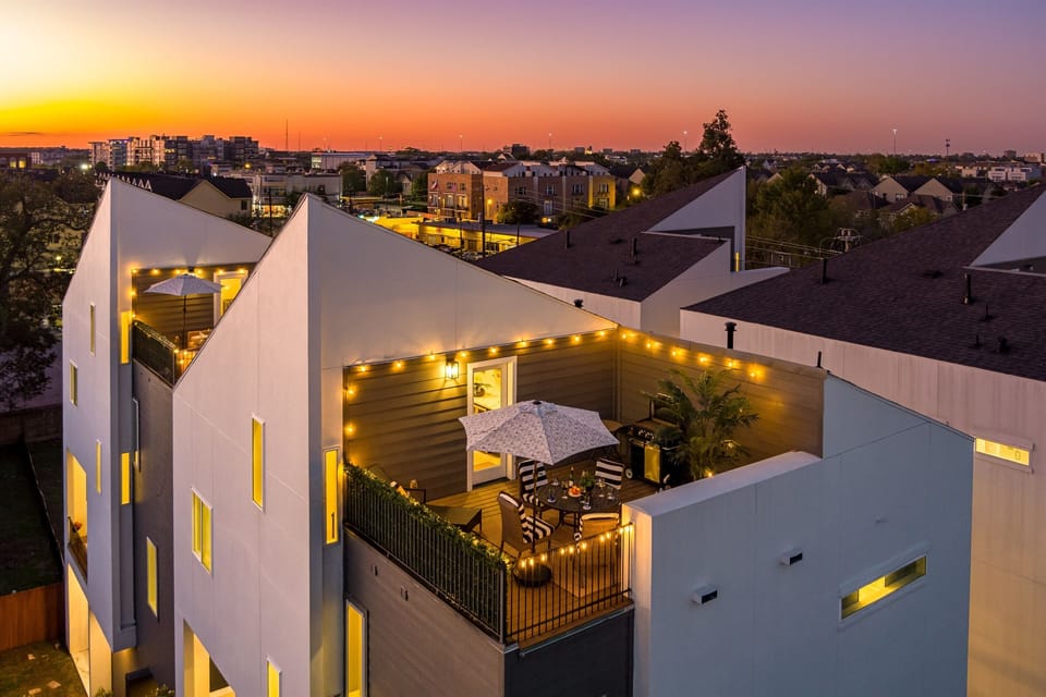 An aerial view of a house with a rooftop deck.