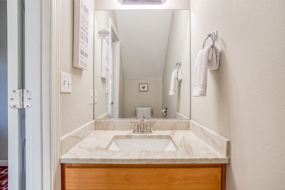 Bathroom: Elegant marble sink and thoughtful decor make your refresh routine delightful!