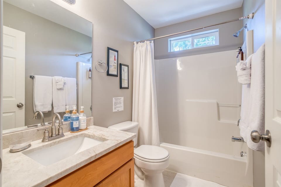 Bathroom Oasis: Bright and airy space with modern fixtures and refreshing coastal decor!