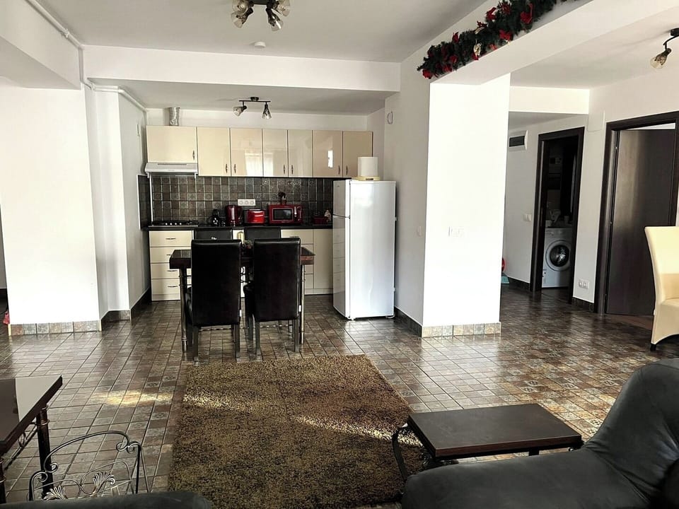 Modern and well-equipped kitchen with sleek, white cabinets and countertops, providing plenty of storage and preparation space; appliances: stove, oven, and refrigerator in excellent condition, allowing you to make home-cooked meals during your stay