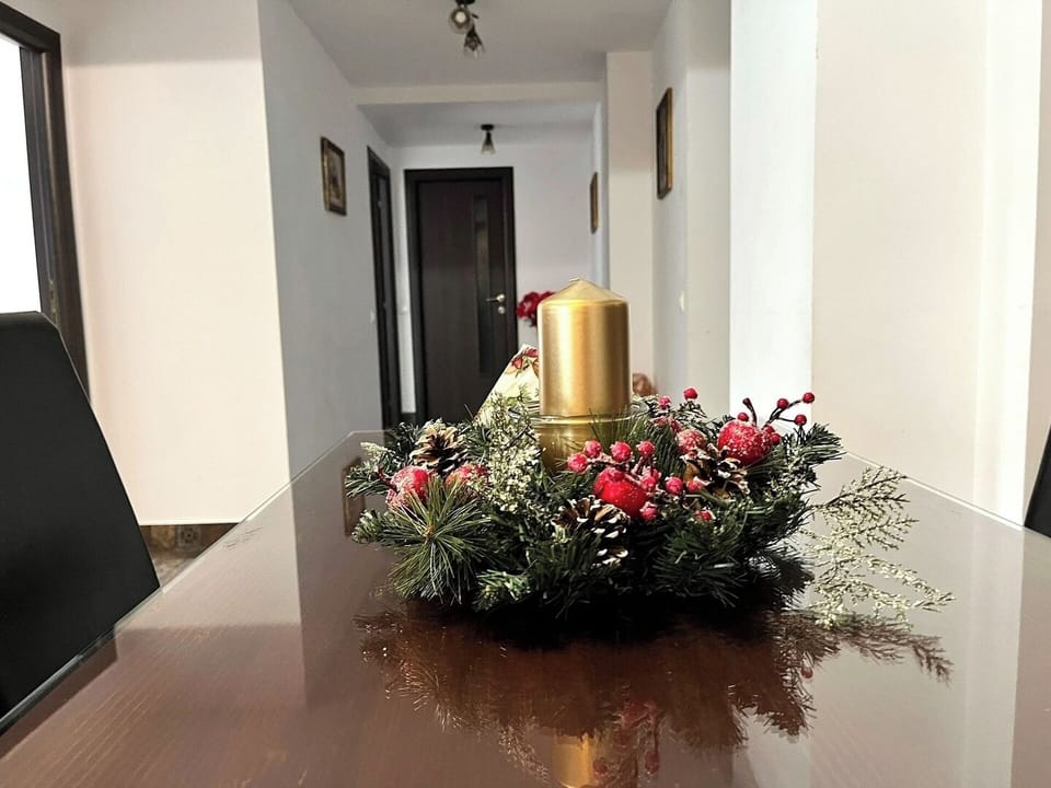 Charming and cozy nook with a comfortable armchair and a floral artwork, providing a quiet and intimate space for relaxation or reading in the open space kitchen in this charming 3-bedroom apartment

