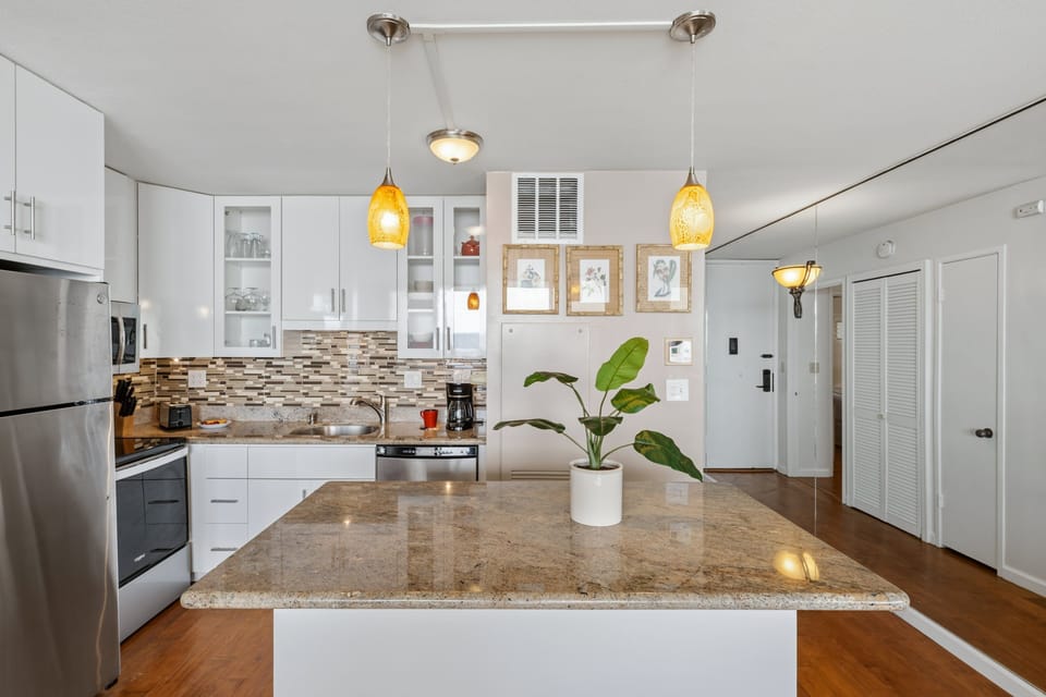 Entertain with ease in this bright, open kitchen featuring sleek granite counters, modern stainless appliances, and a beautiful island.