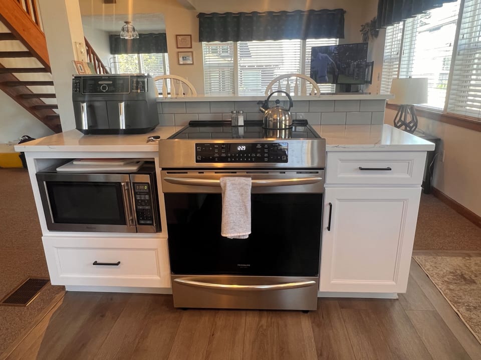 Your modern kitchen features stainless steel appliances and white cabinetry, perfect for preparing memorable meals during your stay.