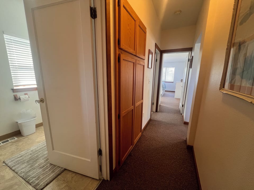 Your private hallway features rich wood cabinetry and thoughtful storage, creating a welcoming path through your home away from home.