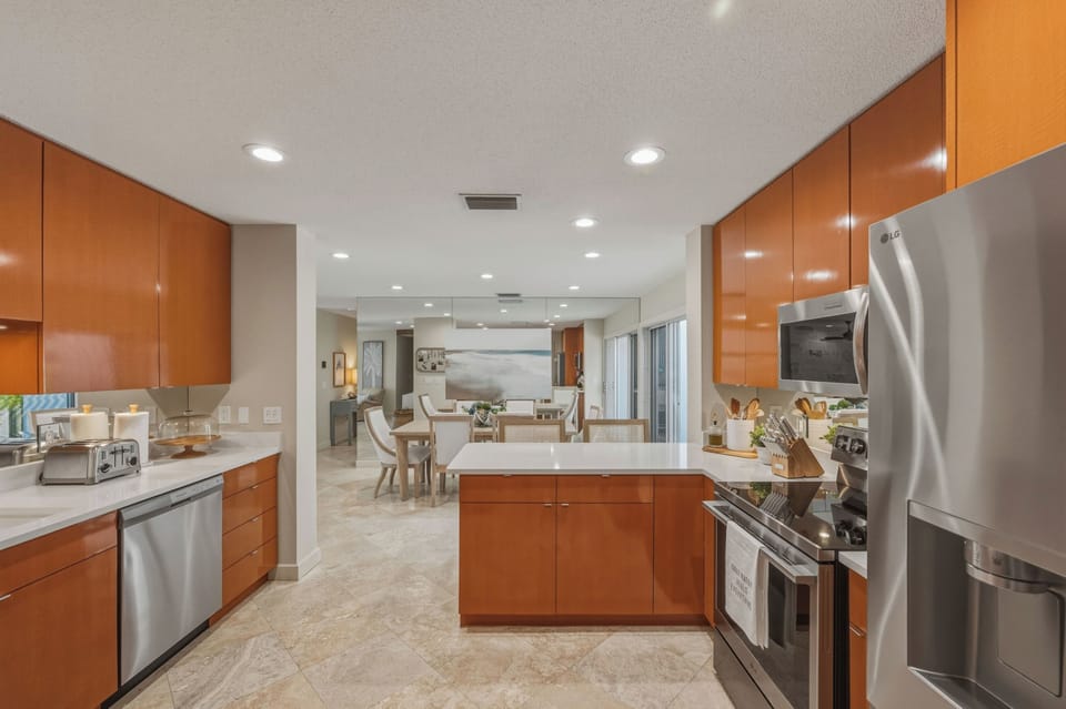 Your modern kitchen features sleek cabinets, stainless steel appliances, and quartz countertops perfect for preparing memorable meals.